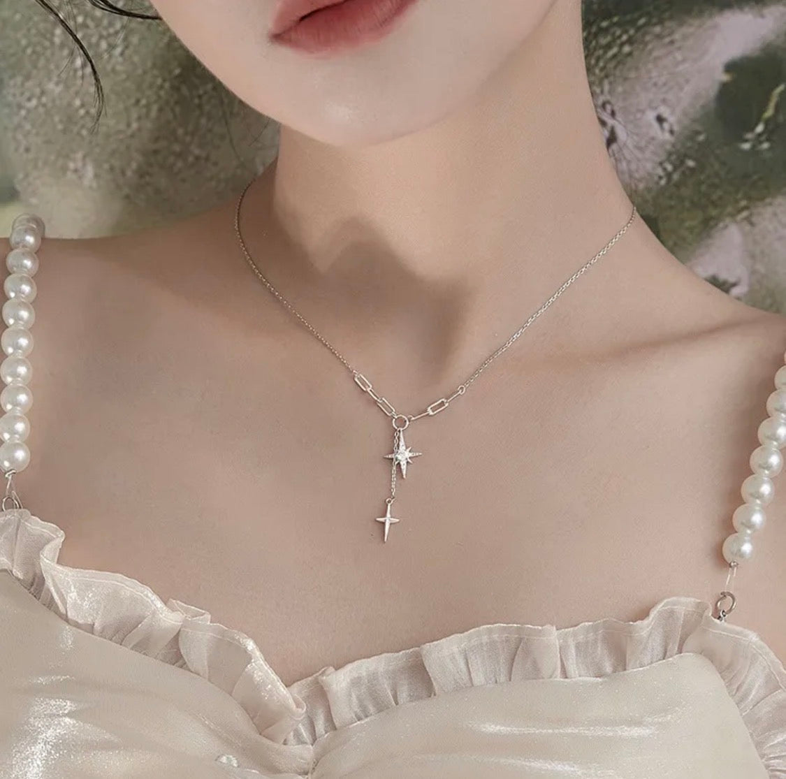 Dual north star lariat necklace product flat lay on white background