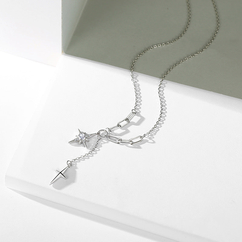 Dual north star lariat necklace worn on model with ruffle top