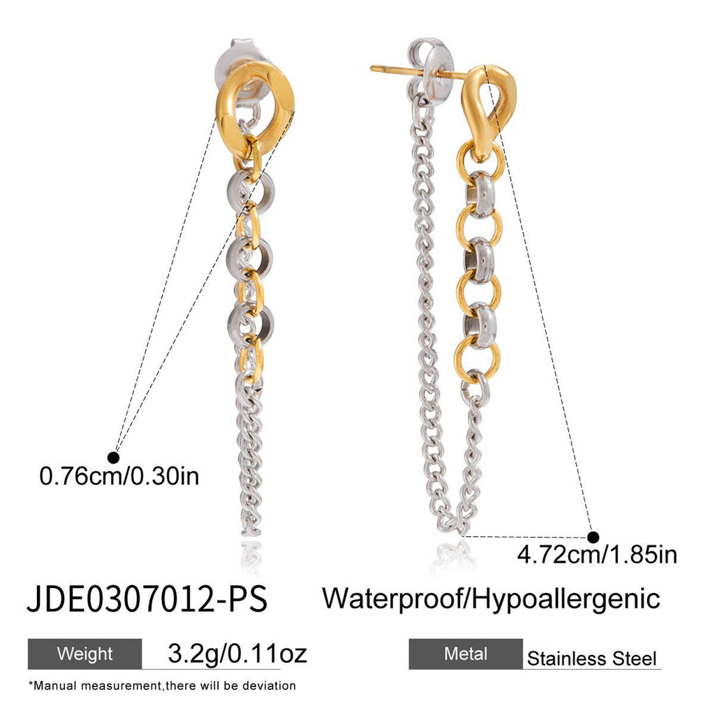 Two-tone chain drop earrings on marble tray with hand cream
