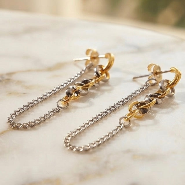 Two-tone chain drop earrings worn on model ear