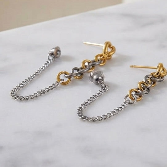 Two-tone chain drop earrings close up detail