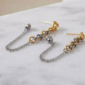 Two-tone chain drop earrings close up detail
