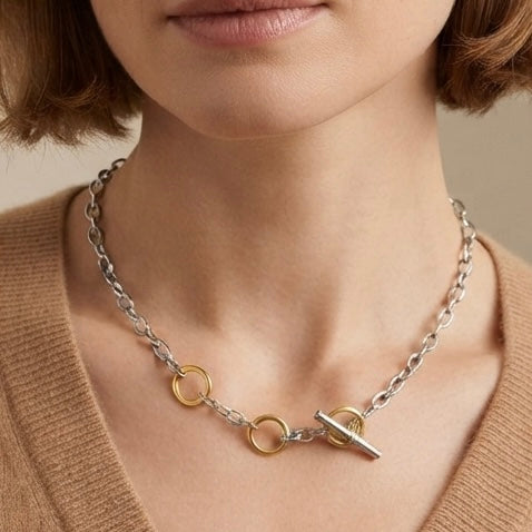 Two-tone OT toggle chain necklace worn on model with camel sweater