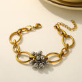 Gold chain beaded flower bracelet product shot on cream background