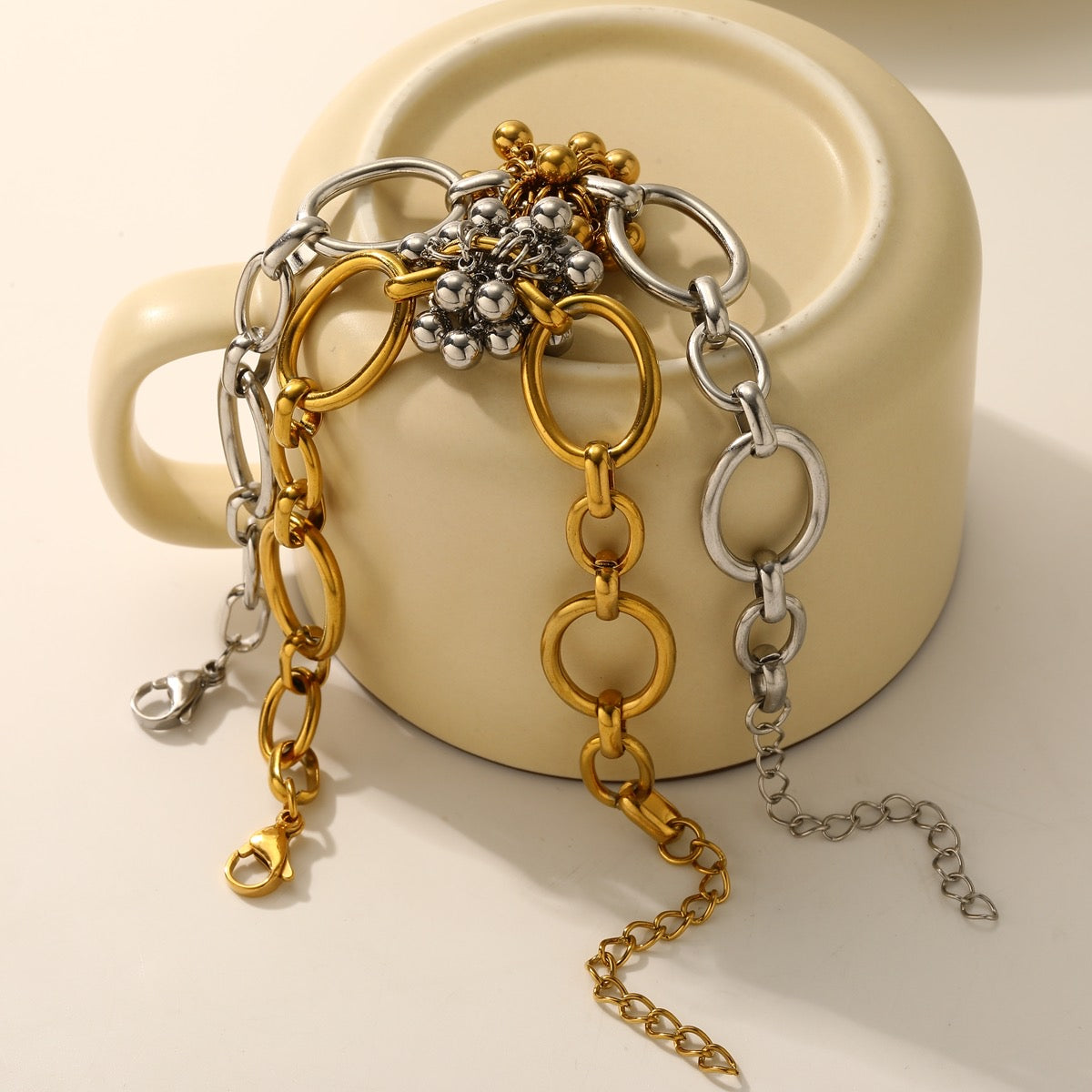 Gold and silver beaded flower chain bracelets side by side flat lay