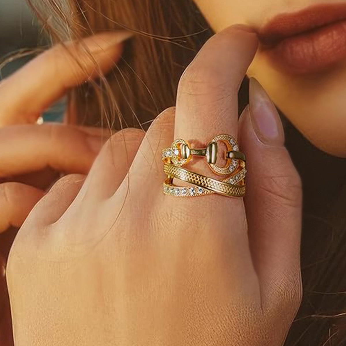 Gold CZ multi-band OT buckle ring worn on model finger close up
