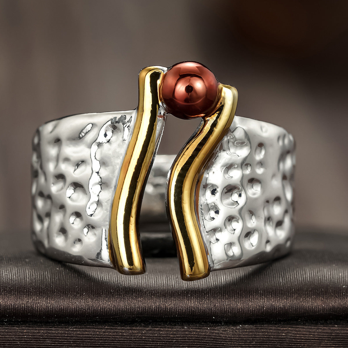 Hammered silver wide-band ring with gold-tone bars and burgundy copper bead accent